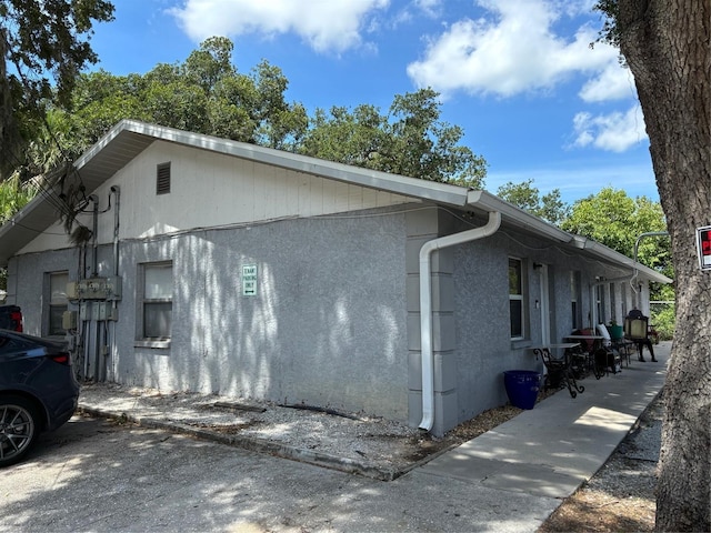 view of side of property featuring stucco siding