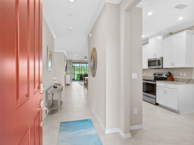 interior space featuring ornamental molding and light tile floors