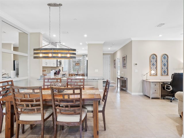 tiled dining area with sink and crown molding