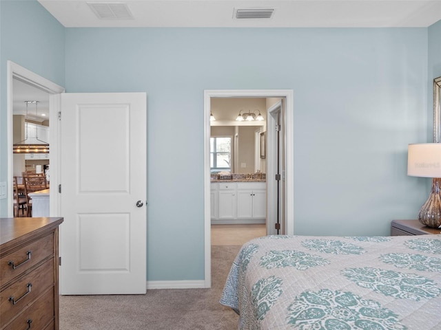 carpeted bedroom featuring connected bathroom