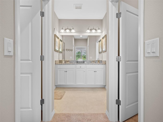 bathroom with tile floors and double sink vanity