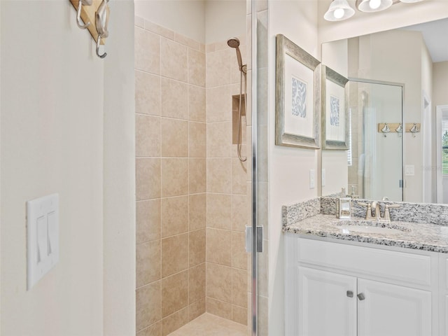 bathroom featuring walk in shower and vanity