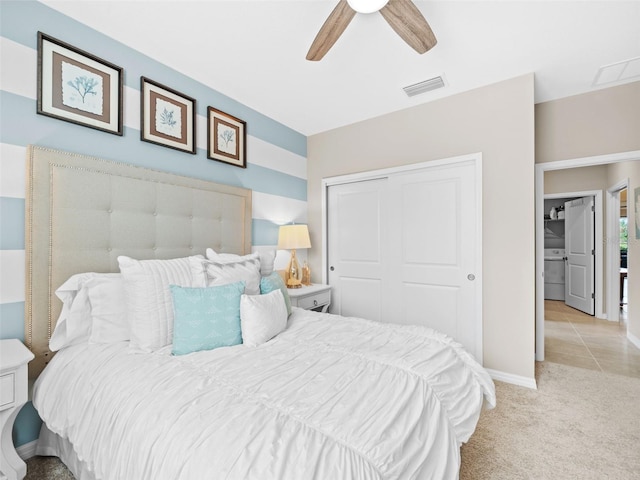 bedroom featuring ceiling fan, a closet, and light colored carpet