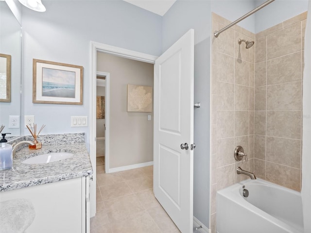 bathroom with tile floors, tiled shower / bath combo, and vanity