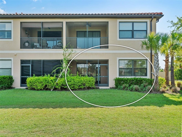 view of front of home with a front yard and a balcony