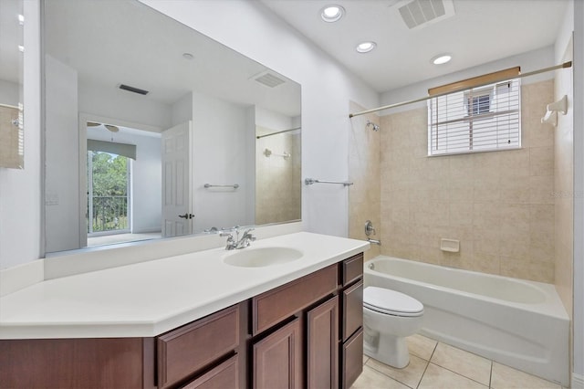 full bathroom with tile patterned flooring, tiled shower / bath combo, a healthy amount of sunlight, and toilet