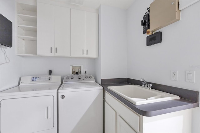 laundry room with cabinets, sink, and washing machine and clothes dryer