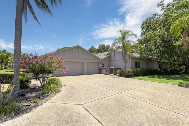 ranch-style home featuring a garage and a front yard