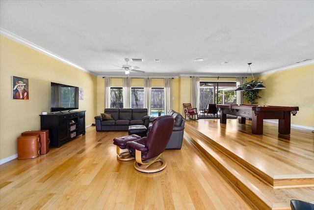 living room featuring crown molding, billiards, and light hardwood / wood-style flooring