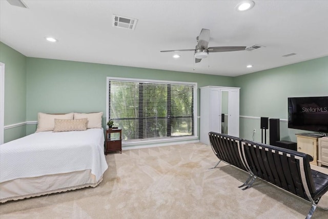 bedroom with ceiling fan and light carpet