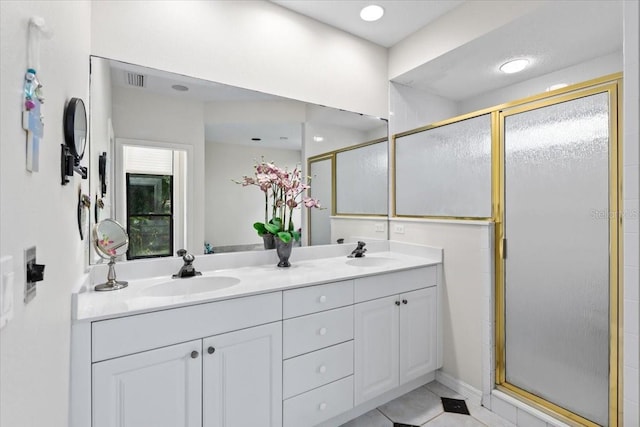 bathroom with tile patterned floors, vanity, and an enclosed shower