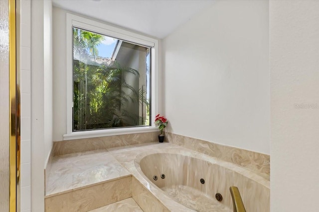 bathroom featuring tiled tub