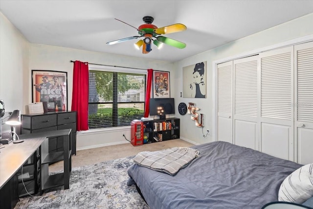 bedroom with ceiling fan, a closet, and light colored carpet