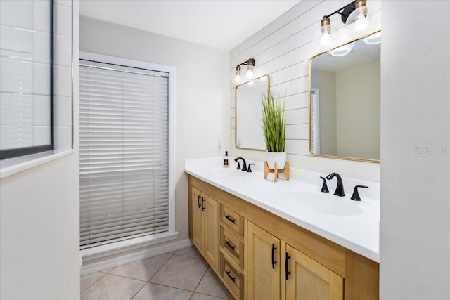 bathroom with tile patterned floors, wooden walls, and vanity