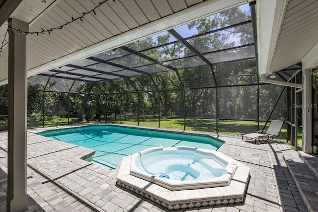 view of swimming pool featuring an in ground hot tub, a patio, and glass enclosure