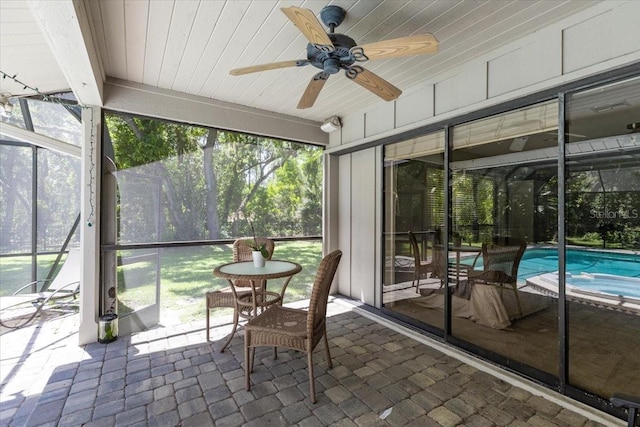 sunroom with a wealth of natural light and ceiling fan