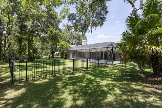 view of yard featuring a fenced in pool and a lanai