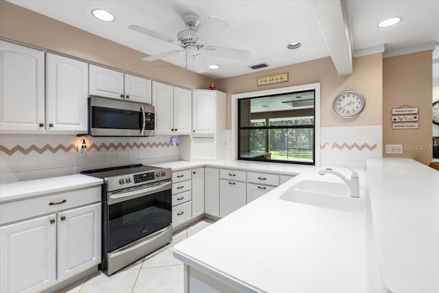 kitchen featuring white cabinetry, sink, kitchen peninsula, and appliances with stainless steel finishes