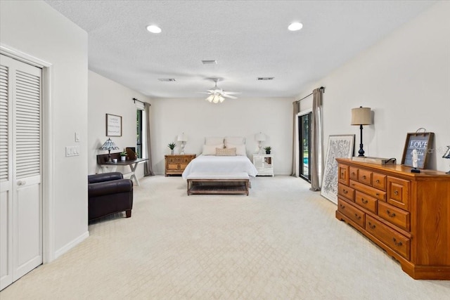 carpeted bedroom featuring ceiling fan, access to outside, and a textured ceiling