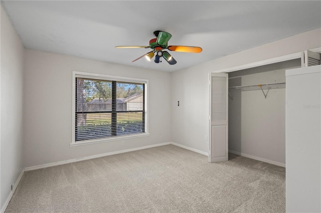 unfurnished bedroom featuring light carpet, a closet, and ceiling fan