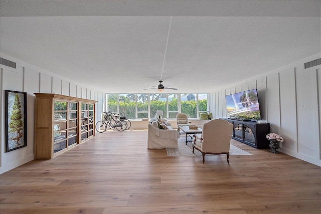 unfurnished sunroom with ceiling fan