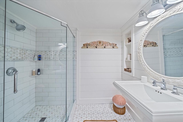 bathroom featuring crown molding, sink, and a shower with door