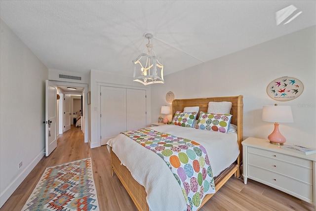 bedroom with a closet and light hardwood / wood-style flooring