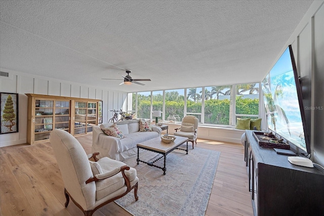 sunroom / solarium featuring ceiling fan