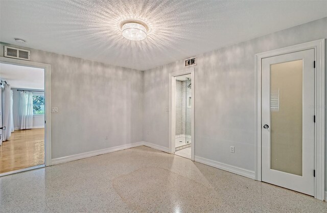 empty room featuring a textured ceiling