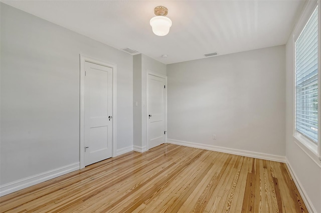 unfurnished room featuring light hardwood / wood-style flooring