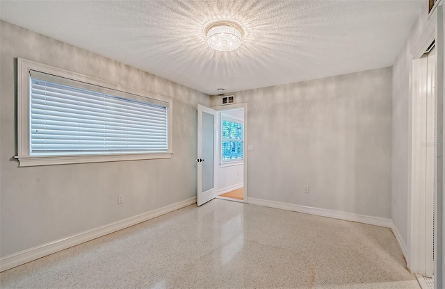 spare room featuring a textured ceiling