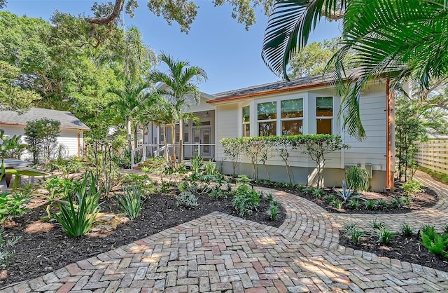 view of front of property featuring a sunroom