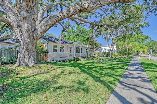 view of front of home featuring a front yard and a porch