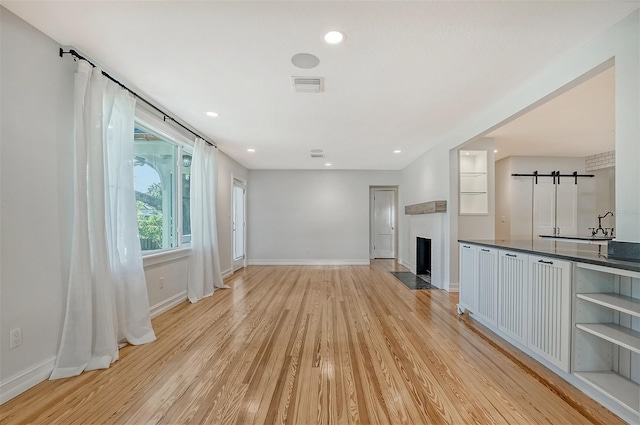 unfurnished living room featuring light hardwood / wood-style floors