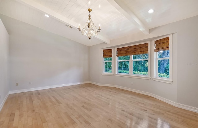 empty room with beamed ceiling, an inviting chandelier, wood ceiling, and light hardwood / wood-style flooring