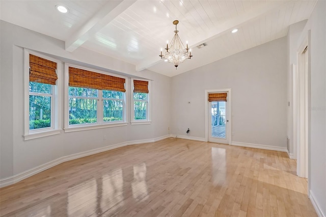 spare room featuring lofted ceiling with beams, light hardwood / wood-style floors, and a notable chandelier