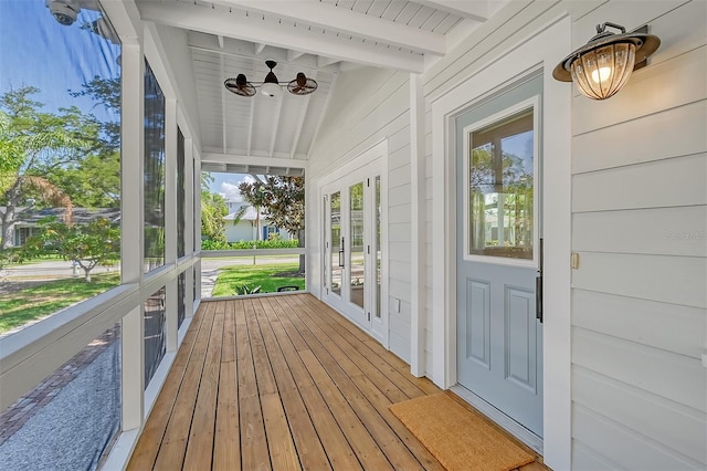 sunroom with vaulted ceiling with beams and a wealth of natural light