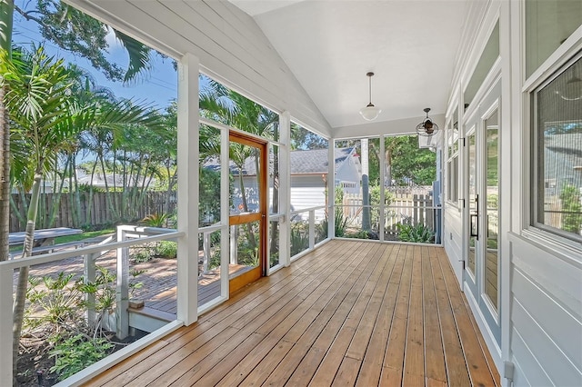 unfurnished sunroom featuring plenty of natural light and lofted ceiling