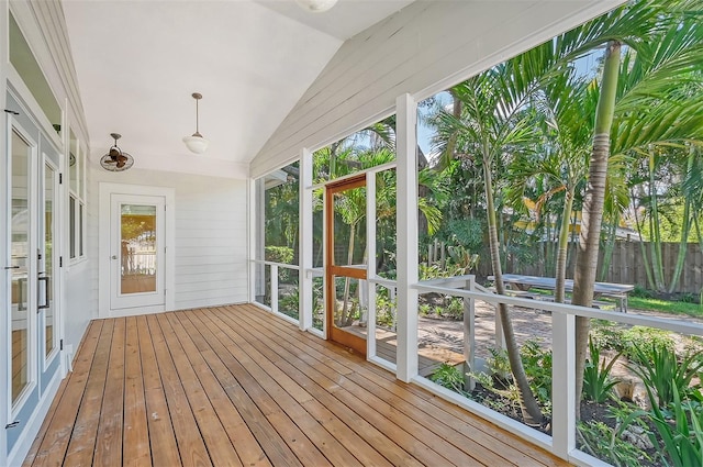 unfurnished sunroom featuring vaulted ceiling