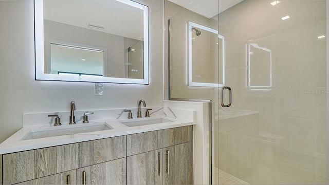 bathroom featuring vanity and an enclosed shower