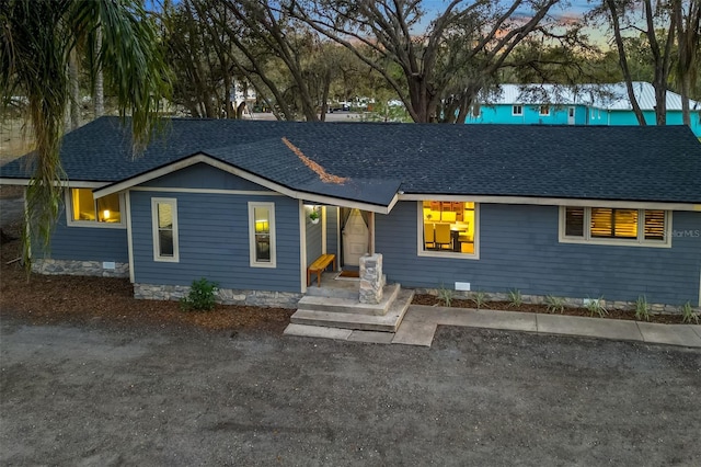 ranch-style home with roof with shingles and crawl space