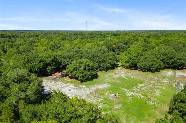 bird's eye view with a wooded view