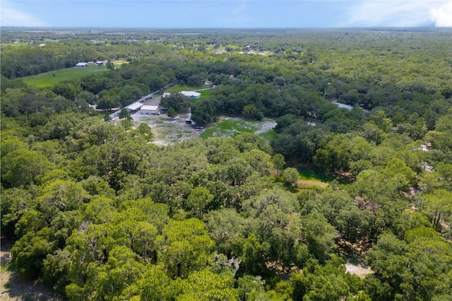 birds eye view of property with a view of trees