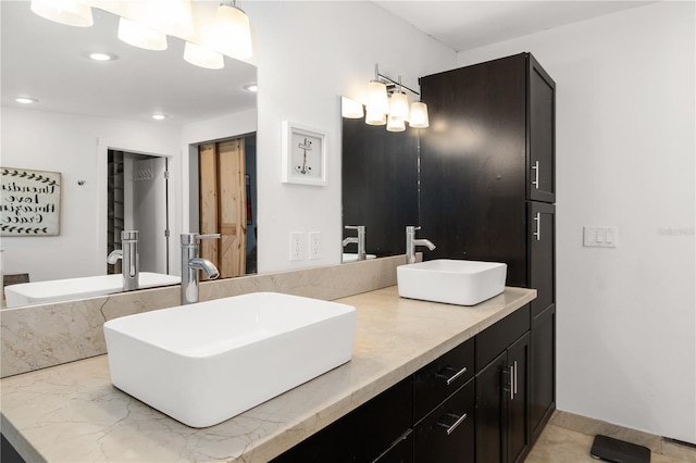 bathroom featuring recessed lighting, a sink, and double vanity