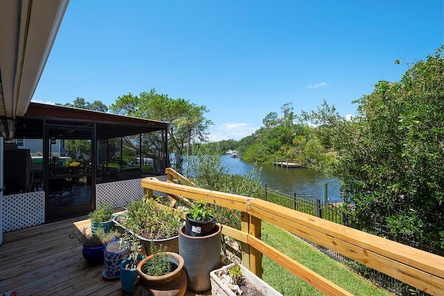 deck featuring a sunroom and a water view