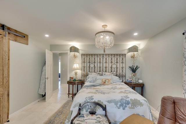 bedroom featuring a barn door and a notable chandelier