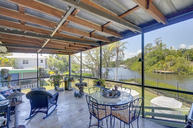 sunroom / solarium with a water view