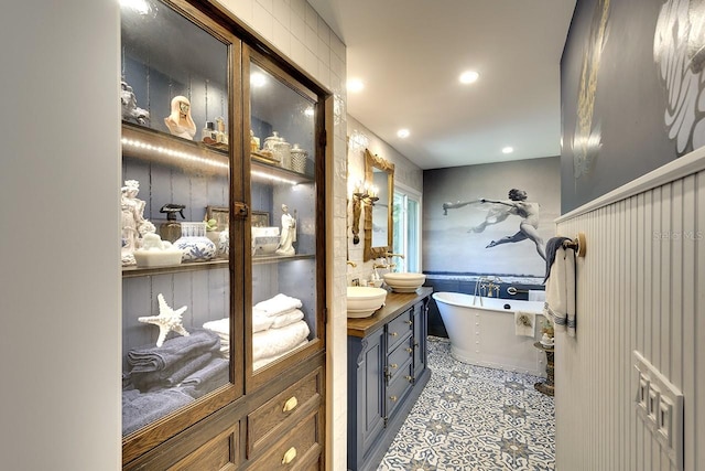 bathroom with vanity and a bathing tub