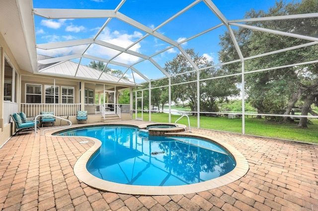 view of swimming pool with a yard, glass enclosure, an in ground hot tub, and a patio