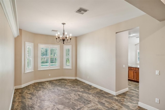 empty room featuring an inviting chandelier